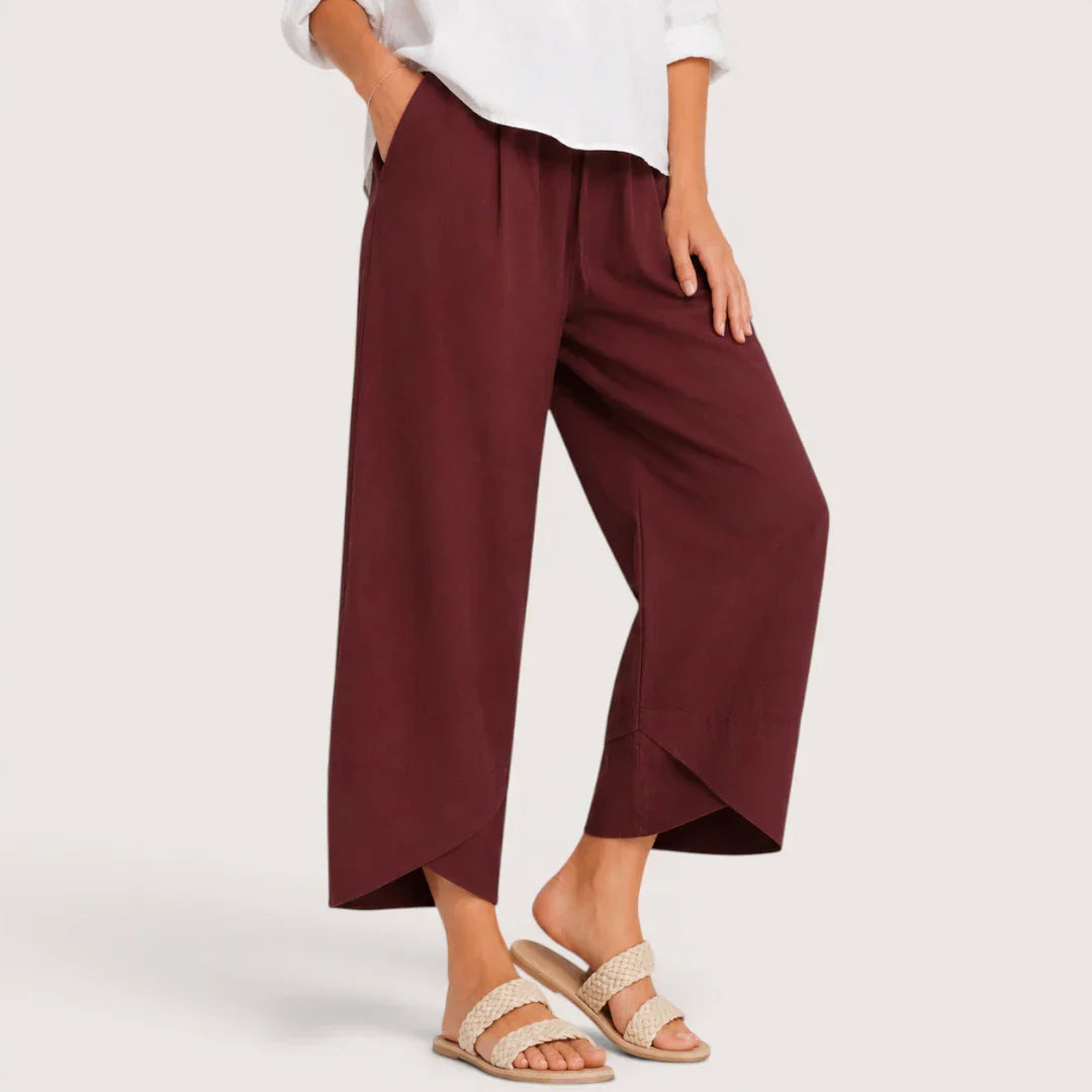 Maroon wide-leg pants worn by a person on a white background