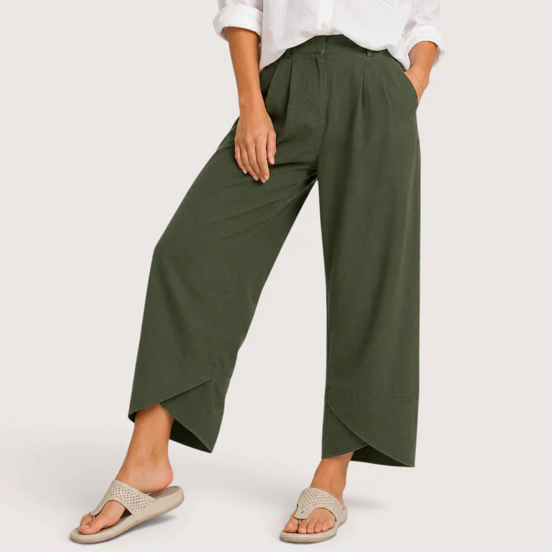 Person wearing green wide-leg pants on a white background