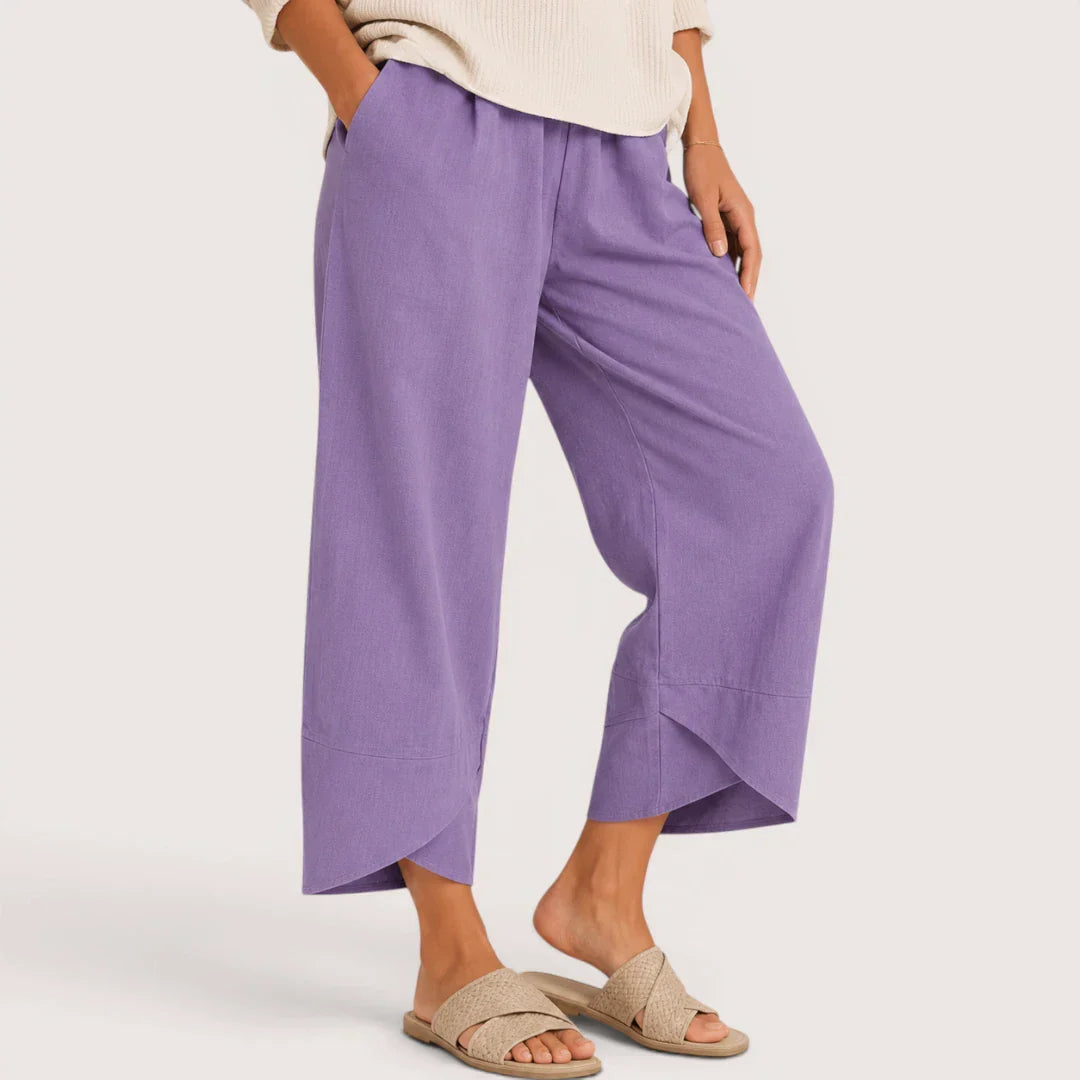 Person wearing purple wide-leg pants on a plain background
